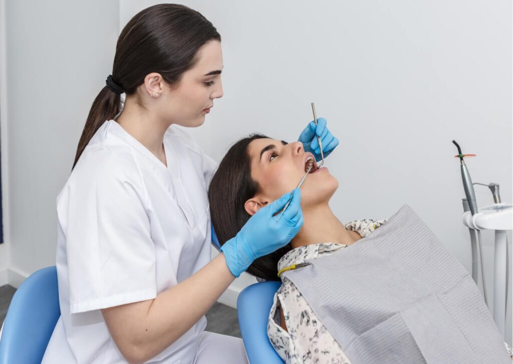 Dentist examining a patient for symptoms of a dental abscess to diagnose and treat an infected tooth.